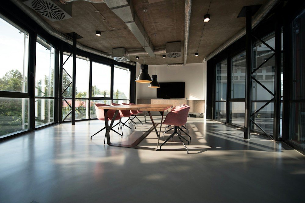 A bright collaborative office with meeting spaces and greenery